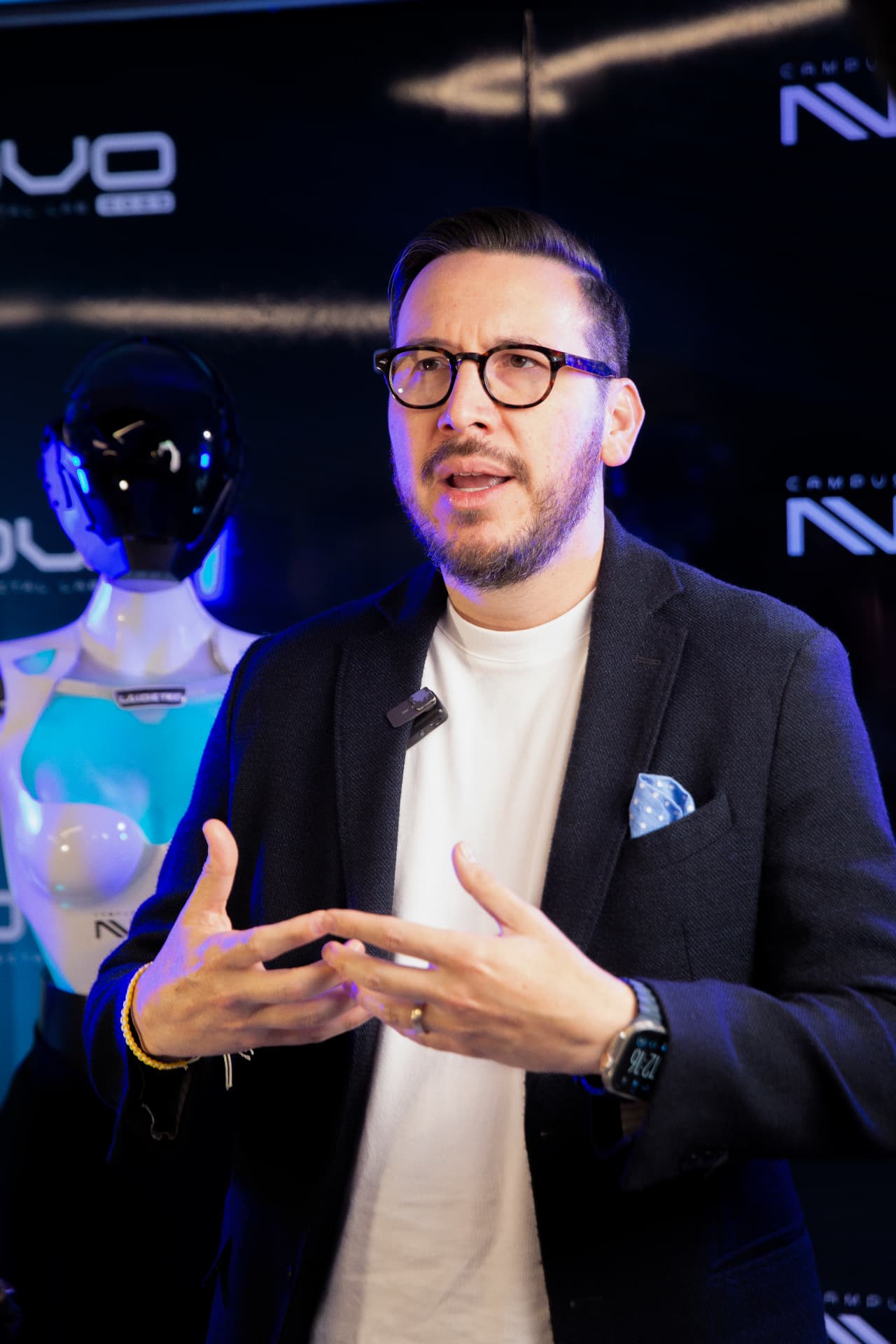 Vocero explicando frente al robot humanoide